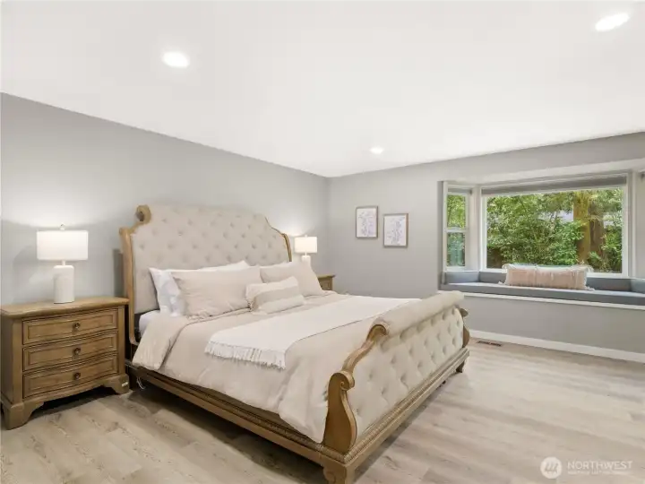 This spacious primary suite truly is a retreat. Sited in the most private corner of the lot, with a bay window that provides plenty of natural light and a spa-like primary bathroom that will delight!