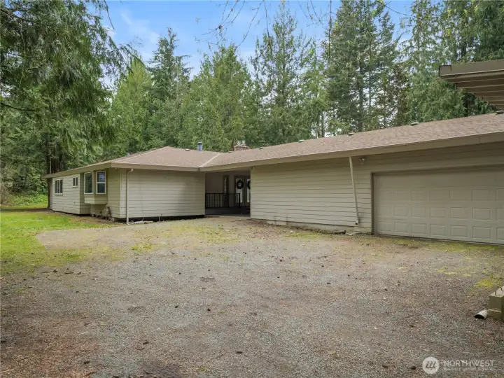 From the back of the house, you can see the 3rd bay door, which makes a perfect entrance for a shop or professional garage, separate from the main home and garage. The port-a-cochere connects the garage to the house and makes bringing in groceries a breeze!
