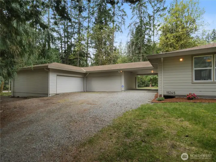 Tucked among the trees on a shy acre, this property offers a spacious driveway with plenty of room for guests, recreational vehicles, and more.