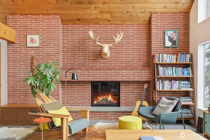 A Roman red brick-surrounded fireplace anchors the space to provide style, flair and warm ambiance all throughout the year.