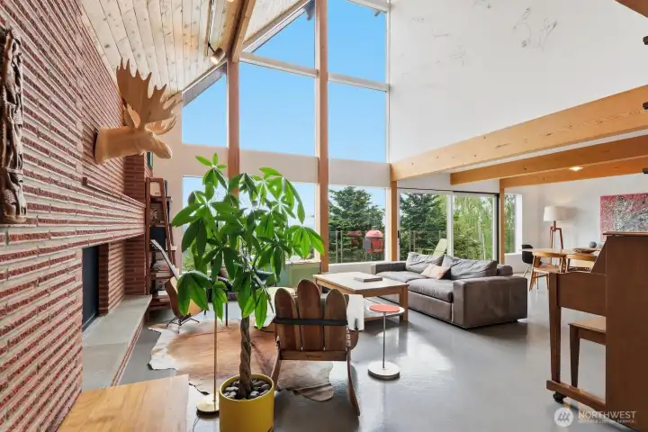 Walls of windows, exposed beams, and clean lines create a space that is both architecturally stunning and conducive to the way life flows.