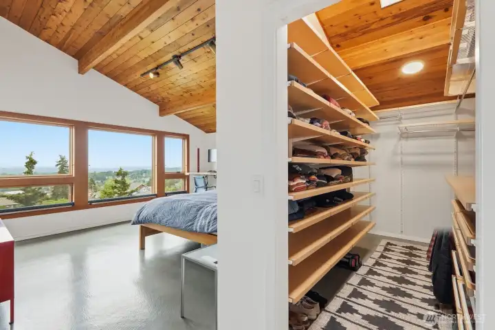 A walk-in closet with custom shelving and organizers ensures that all your favorite pieces have their place.