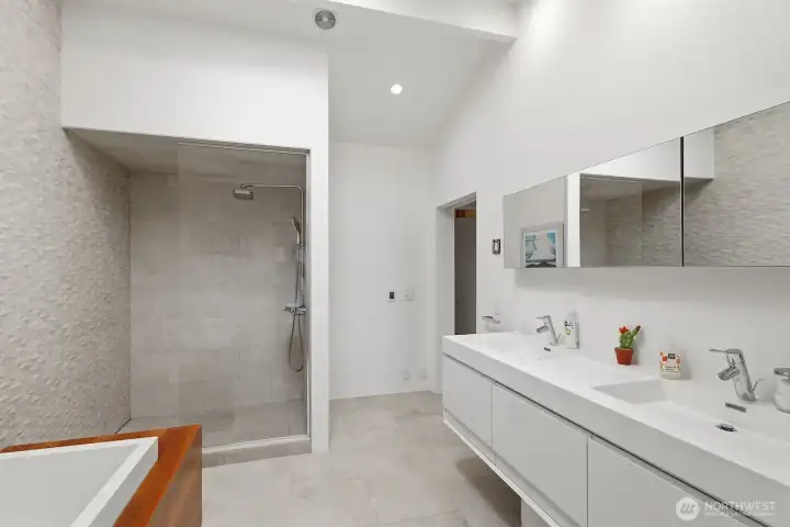 Large glass walk-in shower, a soaking tub, dual vanities, and a skylight to keep the space nice and bright.
