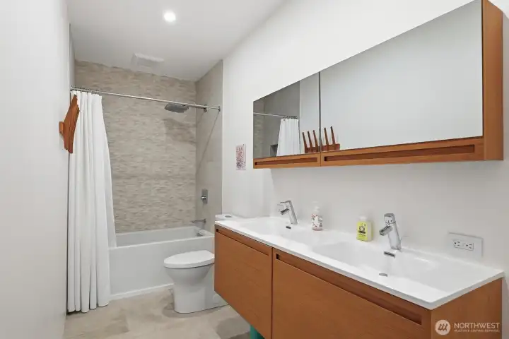 Stylishly appointed full bathroom on the upper level.