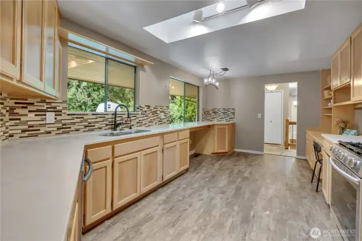 Another view of the kitchen, front windows and skylight. Lots of counter space for all of your cooking projects. Another view of the kitchen, front windows and skylight. Lots of counter space for all of your cooking projects.