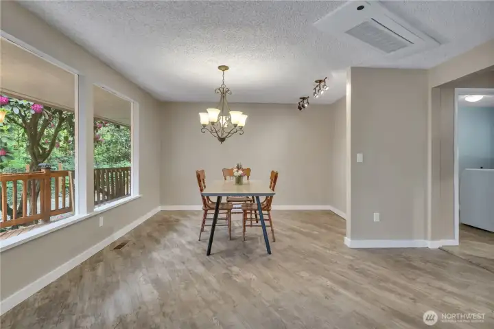 Large dining room accomodates all of your guests and is located right off of the kitchen. Lovely view of the backyard through the picture windows. Large dining room accomodates all of your guests and is located right off of the kitchen. Lovely view of the backyard through the picture windows.