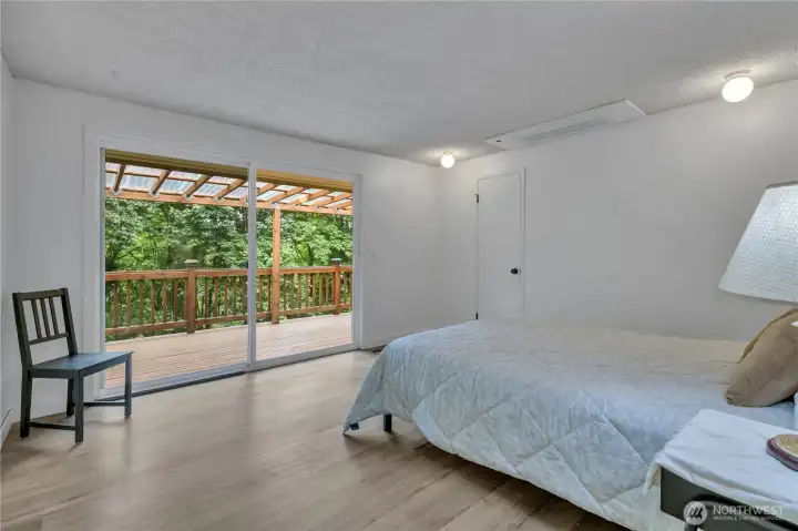Generous primary bedroom with slider leading to the deck. Vinyl plank flooring and 3 closets. Large private bathroom with spa shower. Mini-split is located in the ceiling for your comfort. Generous primary bedroom with slider leading to the deck. Vinyl plank flooring and 3 closets. Large private bathroom with spa shower. Mini-split is located in the ceiling for your comfort.