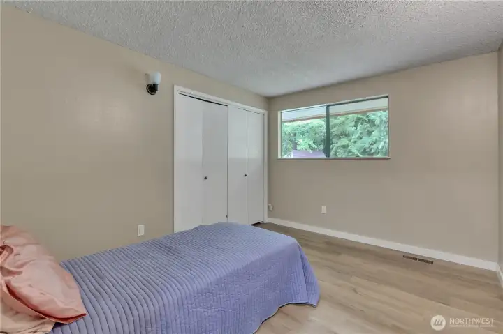 One of two secondary bedrooms on the main level. All bedrooms are spacious and light filled with ample closet space. Vinyl plank flooring and fresh paint too. One of two secondary bedrooms on the main level. All bedrooms are spacious and light filled with ample closet space. Vinyl plank flooring and fresh paint too.