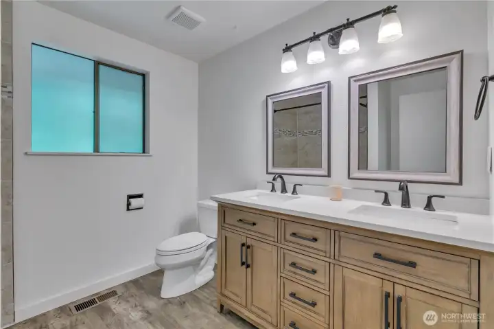 Large hall bathroom with new cabinets and vinyl plank flooring. There is an extra deep soaking tub that is insulated for those long, luxurious baths. Handy double sinks. Large hall bathroom with new cabinets and vinyl plank flooring. There is an extra deep soaking tub that is insulated for those long, luxurious baths. Handy double sinks.
