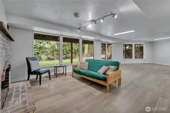 Lower level daylight basement. There is a new slider and large windows to allow lots of light. Vinyl plank flooring and a cozy brick fireplace. Lower level daylight basement. There is a new slider and large windows to allow lots of light. Vinyl plank flooring and a cozy brick fireplace.