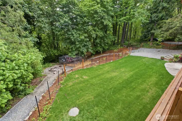 View of the backyard from the deck. It is fenced with 4 gates for easy access. View of the backyard from the deck. It is fenced with 4 gates for easy access.
