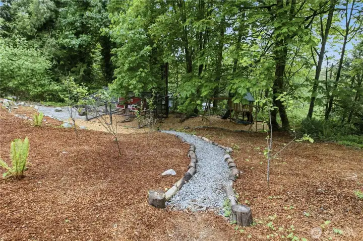 Lovely gravel path leads from the upper yard down to the lower level. Lovely gravel path leads from the upper yard down to the lower level.