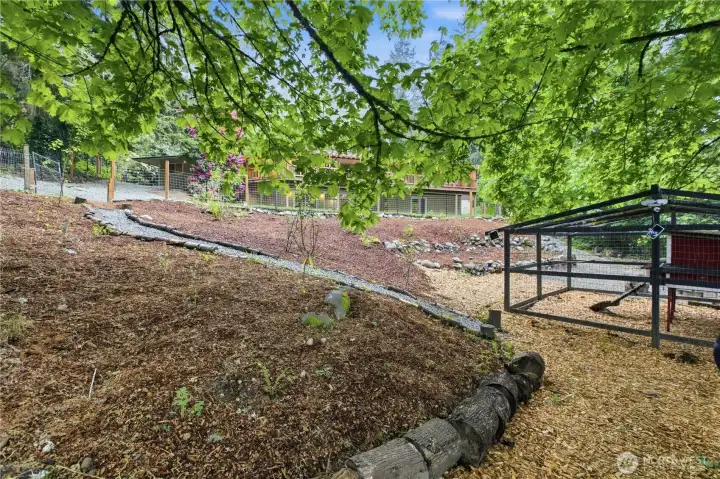 The lower level yard has a chicken coop ready for your new chicks! There is also play equipment and a firepit. The lower level yard has a chicken coop ready for your new chicks! There is also play equipment and a firepit.