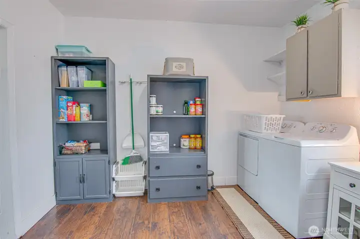 The downstairs bath and laundry room provide valuable everyday function, with extra space that works beautifully as pantry storage or household organization.