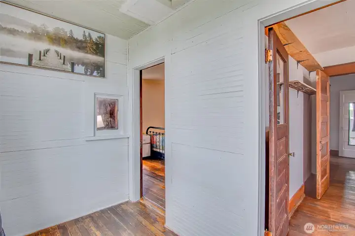 The connected sitting room features a huge window, adding beautiful natural light and creating a flexible space for reading, relaxing, working, or extra bedroom use.