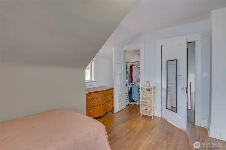 Bedroom with walk in closet and two windows