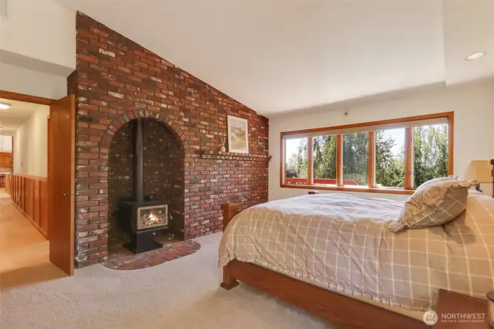 Primary Bedroom w/ wood stove