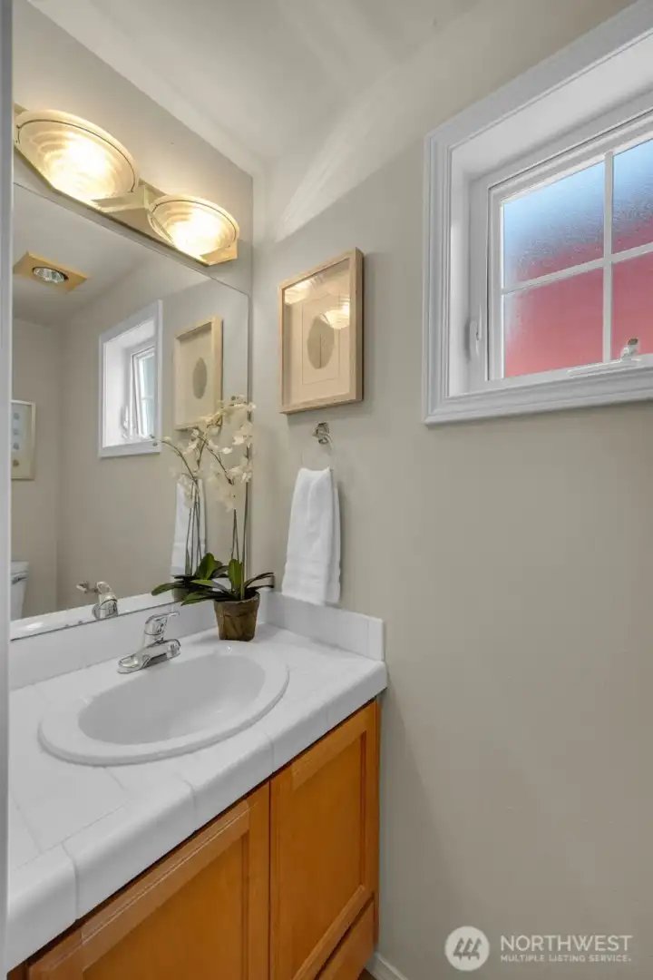 Powder room off of living and kitchen areas Powder room off of living and kitchen areas