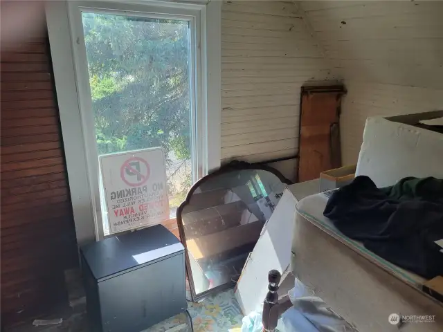 Upstairs bedroom with classic bead board and dormered ceilings.