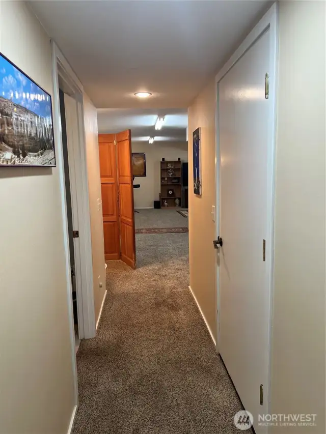 Hall that leads to bathroom with shower and recreation room.
