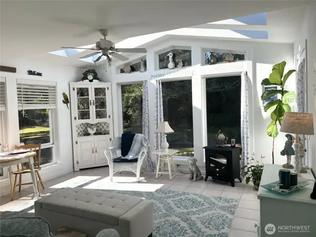 Sunroom with two large skylights and windows.  It is a delightful room.
