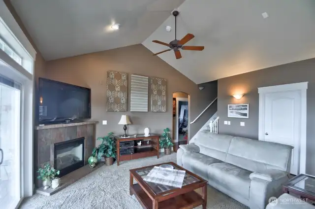 Living room open to the kitchen area with deck access