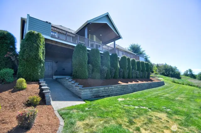View of back of the house and of entrance to the 574 sq ft shop area under the house