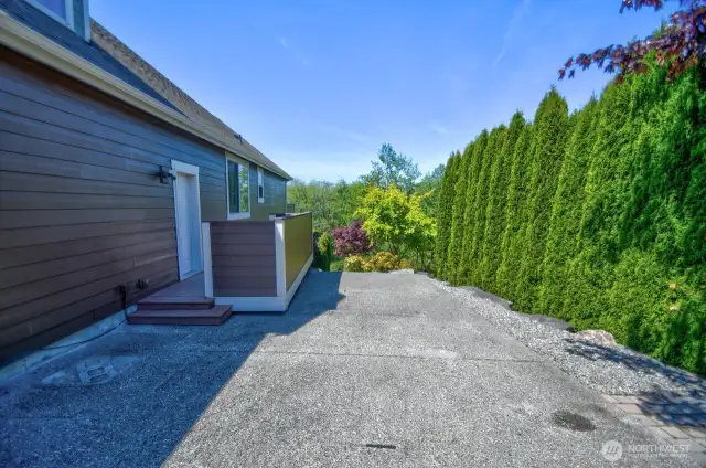 Additional parking to the right of the 3 bay garage. Short term RV parking due to HOA rules
