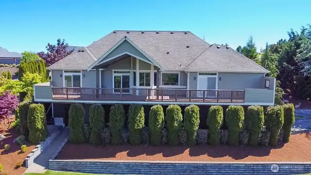 View of the back of the house with composite deck that spans the entire back of the house