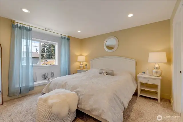 Master suite with the cozy window seat and front garden views.