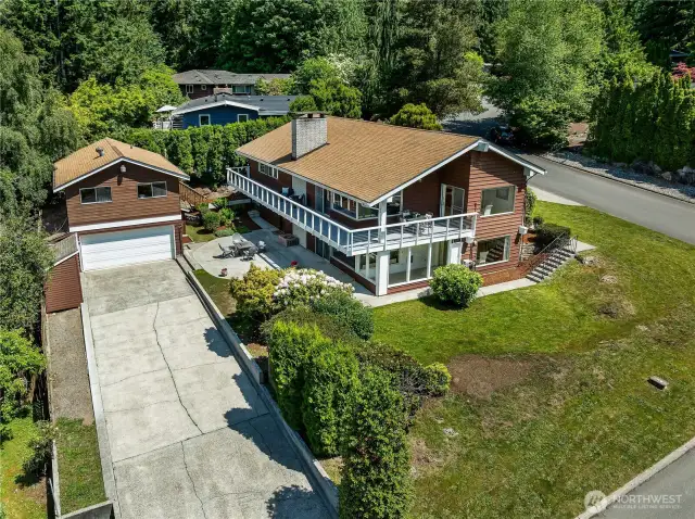 Spacious driveway, wrap-around deck, DADU, and detached garage.