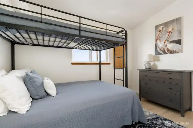 The 2nd bedroom with space for guests/kids and laundry area