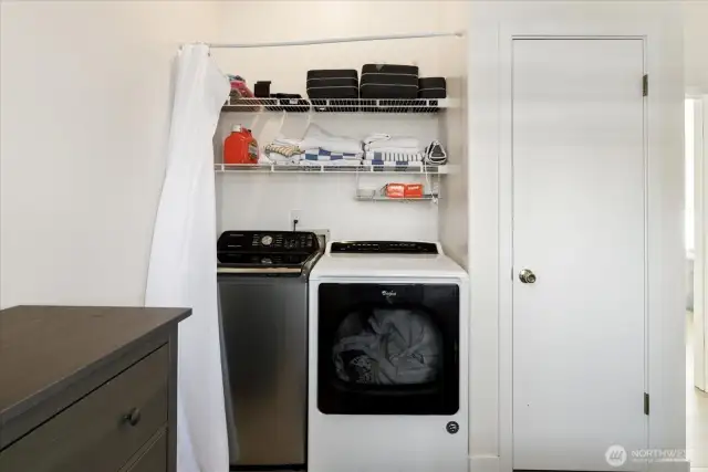 Laundry area hidden behind a curtain in the 2nd bedroom.