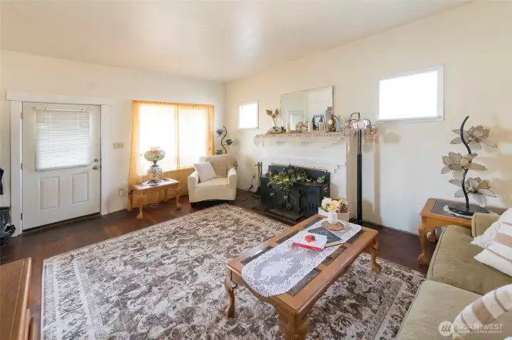 Open and airy living area with abundant natural light and a stylish mantle.