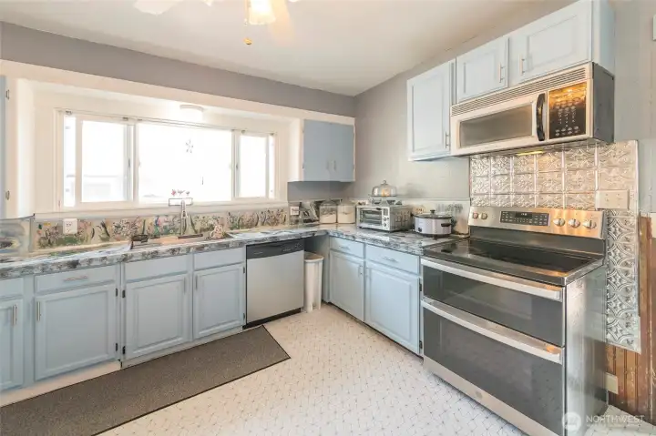 Bright, updated kitchen with new sink and generous cabinetry providing ample storage.