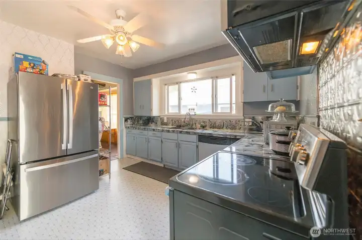 Updated kitchen with stainless steel appliances and double oven, combining modern functionality with style.