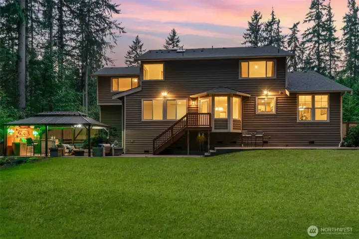Entertaining is a breeze with this NEW outdoor gazebo kitchen featuring a built-in BBQ, bar, & gas fire-table.