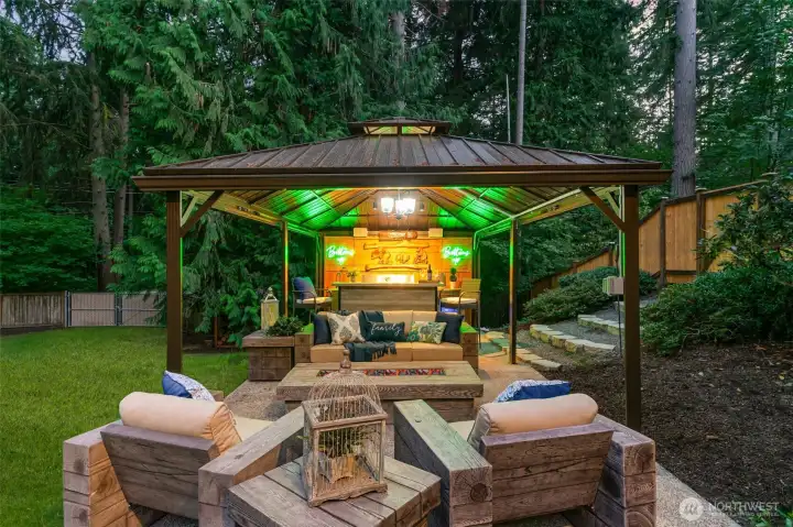 New outdoor gazebo kitchen features a built-in BBQ, Bar, & gas fire-table.