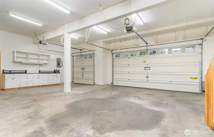 Three-car garage with EV Charger, Generator, RV plug & shop space.