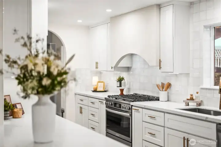 Large kitchen with custom range hood vent