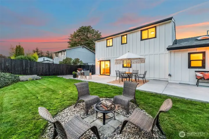 Fully fenced backyard with fire and patio