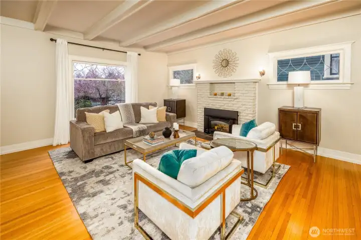 Entertain and live in style! The gracious living room is complete with coffered ceilings, picture window, and original fireplace with gas insert.