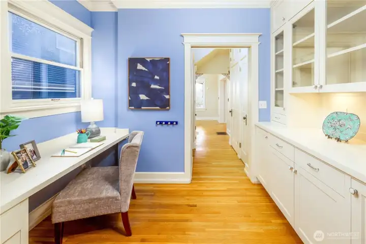 This built-in nook is the perfect in-home office with cabinets and built-in shelving.