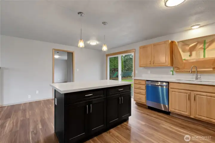 New Stainless appliances and new island with quartz counters