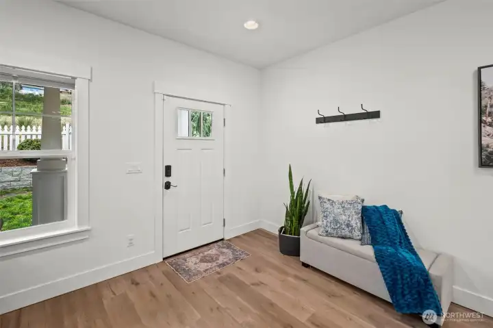 Welcoming entry features eng. hardwoods that flow through the main level.