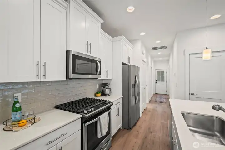 Crisp white cabinets, quartz counters and newer stainless appliances