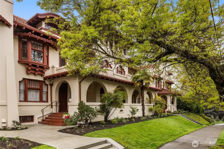 The exterior features stucco walls, decorative parapets & a red terracotta tiled roof. Surround by well maintained grounds.