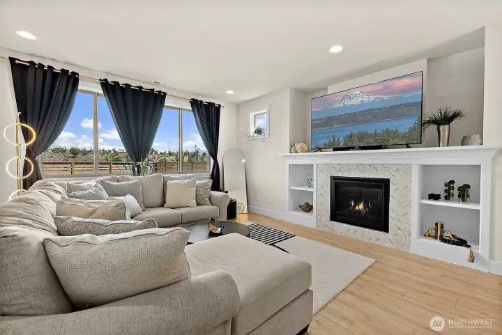 Family room with built-ins, fireplace and views out to the back yard and greenbelt beyond.