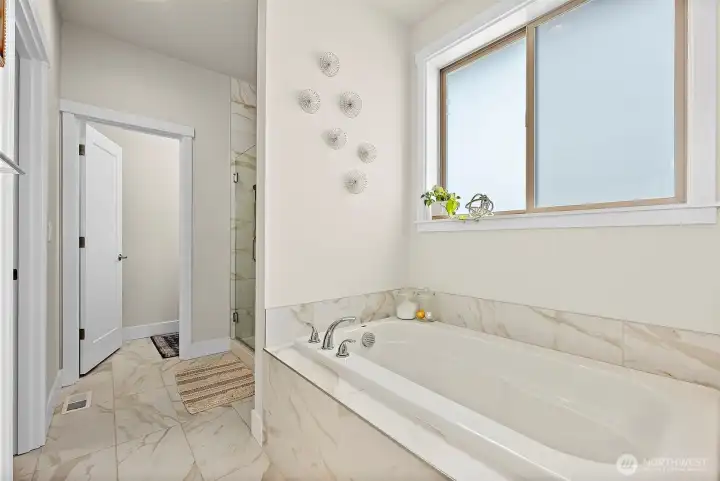 Soaking tub and shower. Notice the natural light that the window allows in the bathroom?