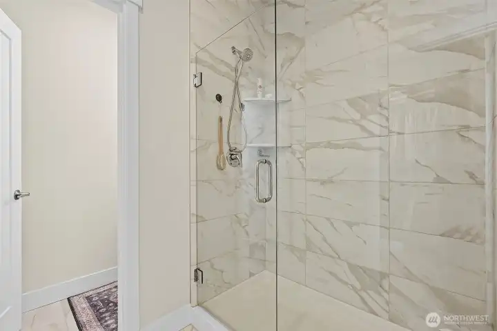 Frameless glass door large tiled shower